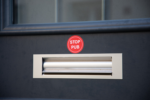Mailbox with text sticker label written in French stop pub in concept of unsolicited advertising and invasive flyers in France