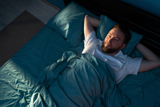 istock Stressed man feels from insomnia trying to sleep in his bed at night 1997067524