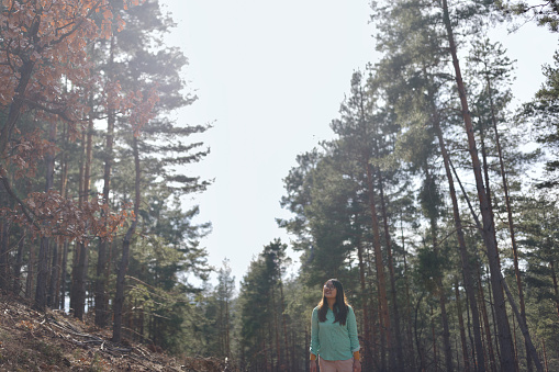 Multiracial woman walking and exploring the forest