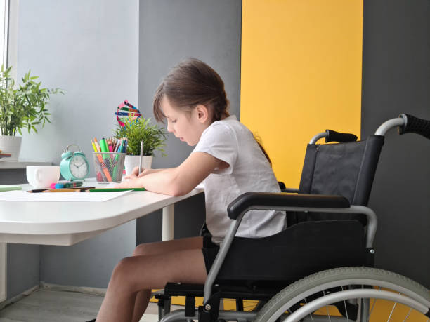 istock Disabled child schoolgirl with homework in class at school 1997072730
