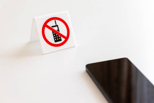 istock A tag indicating that cell phone use is prohibited and a smartphone 1997075413