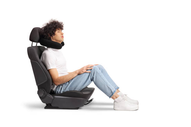 istock Guy in a car seat with a travel pillow around neck 1997076480