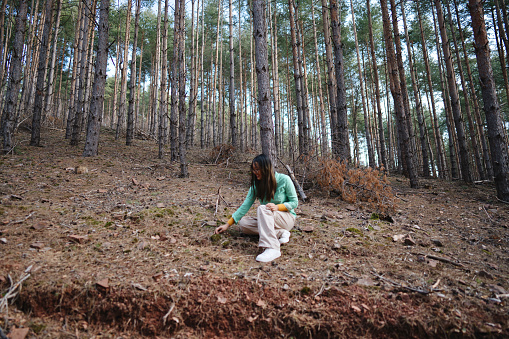 Multiracial woman exploring nature in the forest