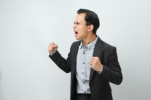 Andry mad asian indonesian business man in suit on isolated background