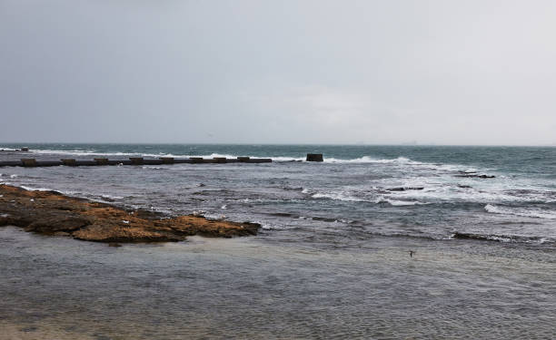 istock Majestic seashore with waves crashing on the Mediterranean pier 1997095778