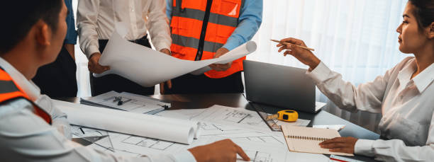 istock Engineer partner drawing and working on blueprint design together. Insight 1997101050