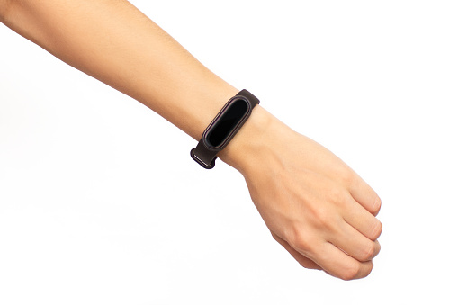 Cropped shot of a woman's hand holding a smart watch with a black display isolated on a white background. Fitness bracelet with copy space close-up. Concept of time, health care, modern digital gadget