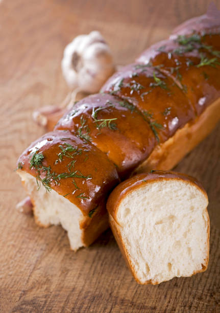 istock Garlic and herb bread, tasty bread with garlic lying on white background 1997124850