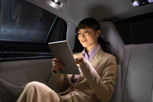 istock Rich business people in luxury car. 1997158913