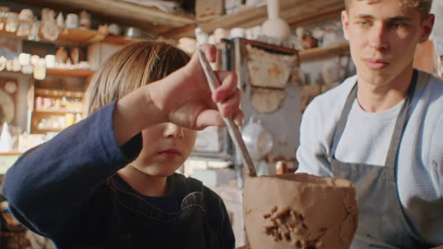 Workshop of dreams, where clay meets child's creativity, hands sculpting traditional pottery, the craft of ancient arts reborn