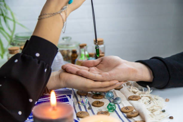 istock A fortune teller reads with tarot cards. Selective focus. 1997162287