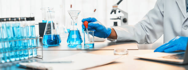 istock Scientist drop precise amount of liquid from pipette into test tube. Neoteric 1997202512