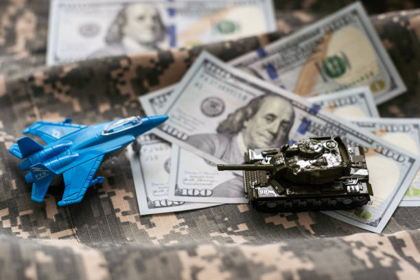 istock Toy fighter. Airplane model on dollars background. 1997223656