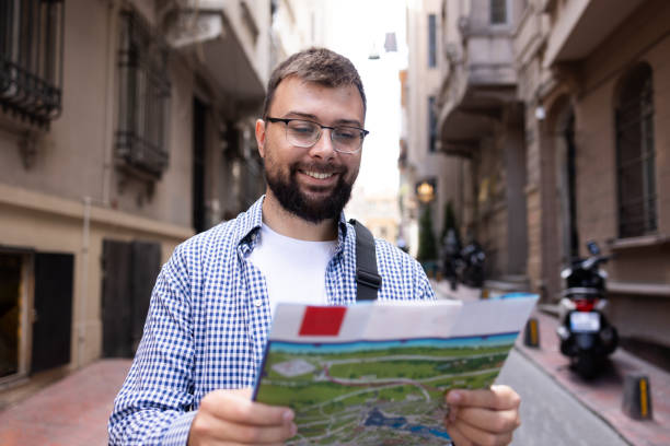 Free Stock Photo of Man in the city, looking at a paper map | Download ...