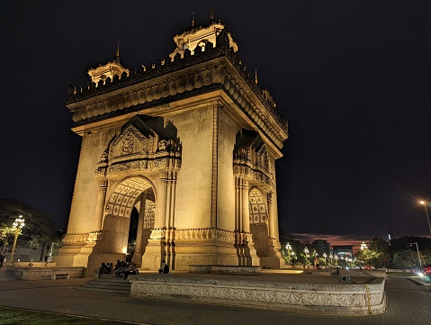 Patuxay  Vientiane, Laos. Patuxay park at night with illuminated Gate of Victory - famous landmark in Vientiane, Laos