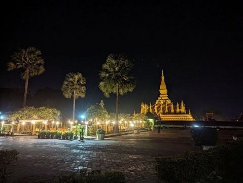 Night shot of Pha That Luang old golden Buddhist pagoda in Vientiane twilight time, Laos.