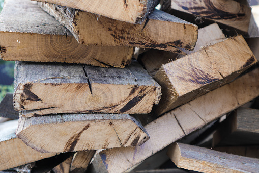 Old oak boards sawn for firewood. Oak cut. Close-up of tree stump in oak. Firewoods