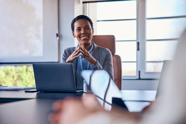 istock A smiling African female boss, interviewing someone at her office. 1997259875