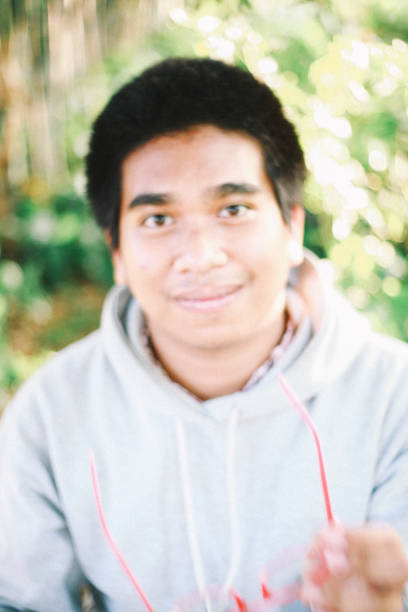 Venice. Italy - October 26, 2019:  headshot of a teenager child looking at camera wearing baseball cap