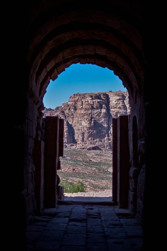 View of a landscape of mountains and desert from inside a house carved into the rock in the ancient city of Petra, Wadi Musa, Jordan.
