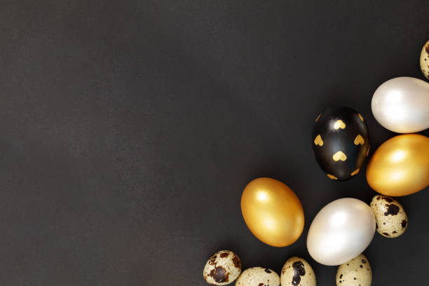 istock Gold, black and white Easter eggs on a dark background. 1997290359