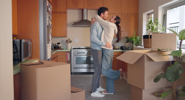 Growth, kiss and hug with a couple in their new home together for celebration or real estate investment. Property, mortgage or love with an excited man and woman embracing while moving house
