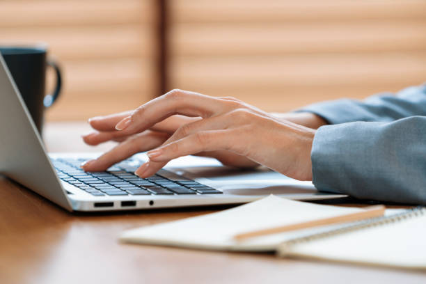 istock Businesswoman typing on laptop, working on business on workspace table. Blithe 1997299987
