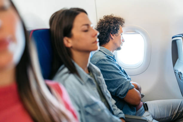 istock Three Young People Sleeping In An Airplane 1997308369