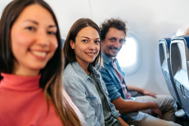 istock Three Young Friends In An Airplane 1997313345