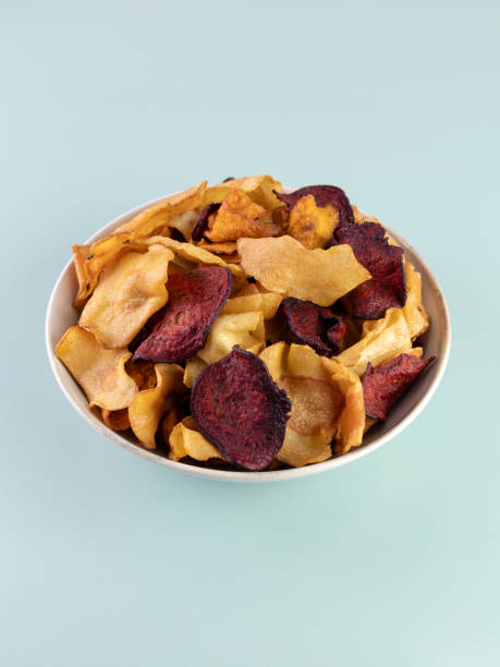 istock A bowl of vegetable organic chips made from beets, carrots and celery root on a gray background. Top view. 1997314180