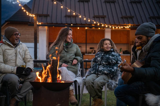 Group of people enjoying around fireplace stock photo