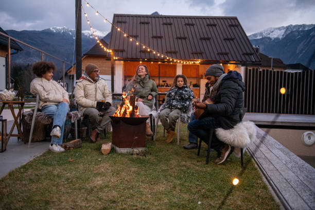 istock Group of people enjoying around fireplace 1997322140