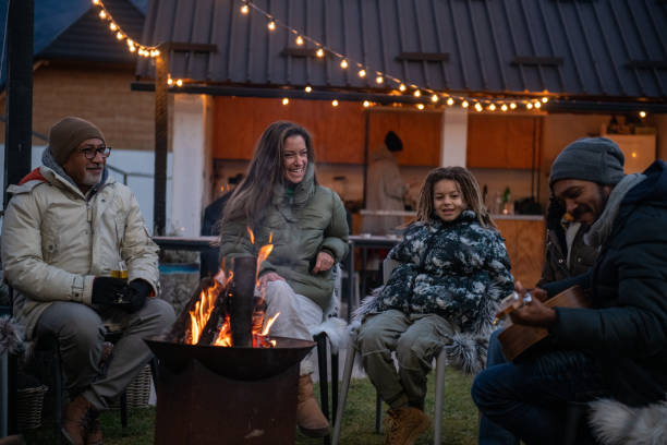 istock Group of people enjoying around fireplace 1997322670