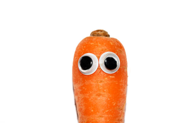istock Silly Food Vegetable Carrot with Goggly Wobbly Eyes on them 1997333695