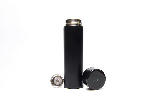 Black thermos with a strainer and a thermometer in the lid on a white isolated background.