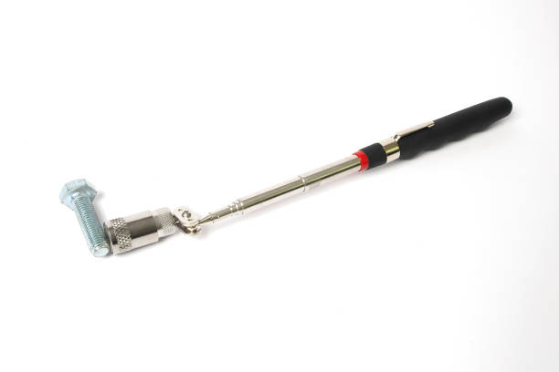 istock Magnet with a telescopic tube and a flashlight on a white background. A handy tool for car repair. 1997337479