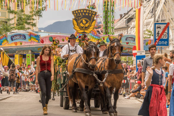 Villach, Austria - August 6, 2022: A horse-drawn carriage at the procession of 'Villacher Kirchtag', the largest traditional folk festival in Austria, after some years of cancellation due to Covid.