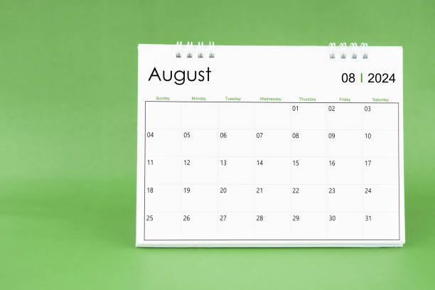 istock August 2024 desk calendar isolated in green background. 1997344340