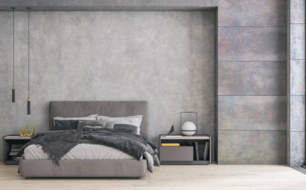 istock Modern bedroom interior: a room with a gray textile double bed in front of a concrete wall and niche with windows and decoration 1997344862