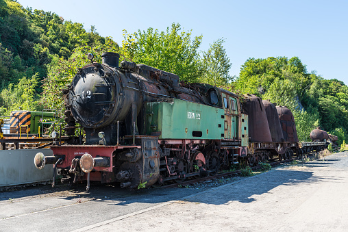 Hattingen, Germany - August 9, 2022: Steam Engine EBV 12 with slag pots at in Hattingen's industrial museum, in the disused ironworks Henrichshuette. LWL Museums of Industrial Heritage.