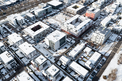 Aerial view of a residential neighborhood in the snow on a sunny winter day.