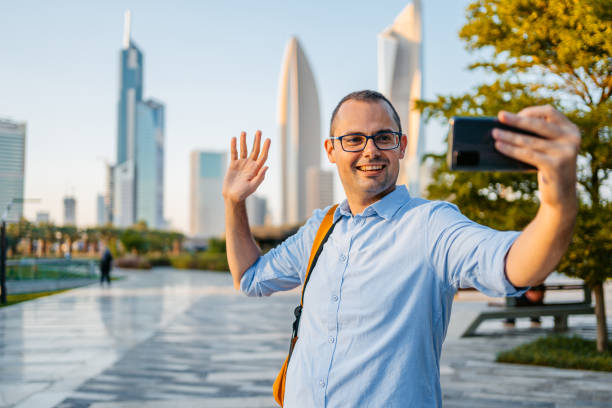 istock Young Man Having A Video Call In The Al Shaheed Park In Kuwait City 1997382283