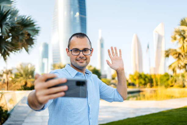istock Young Man Having A Video Call In The Al Shaheed Park In Kuwait City 1997384369