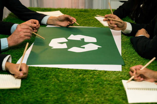 istock Recycle icon on meeting table with business people. Quaint 1997403416