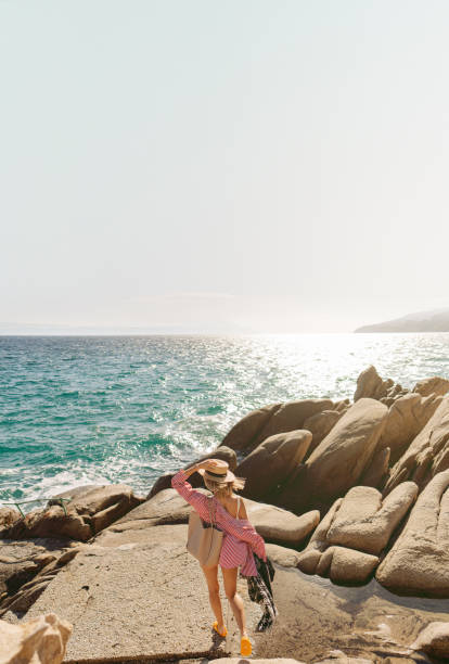 Photo of a woman traveling solo by the sea