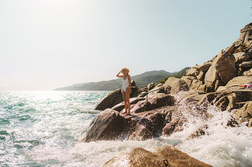 Photo of a woman traveling solo by the sea