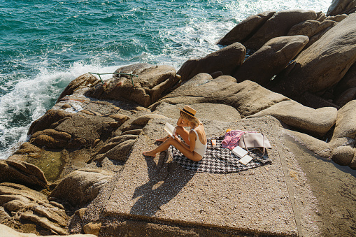 Photo of a woman traveling solo by the sea