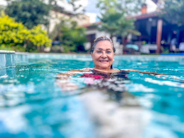 istock Senior Hispanic woman in swimming pool 1997426129