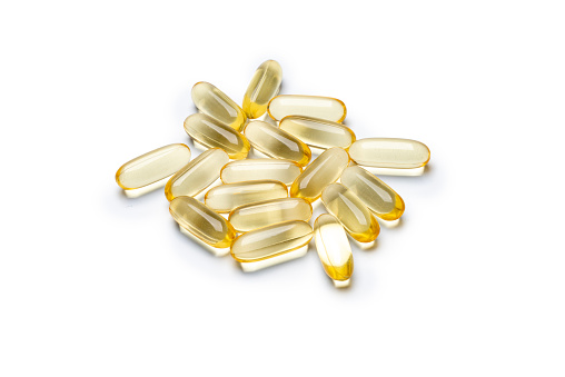Omega 3 pills. Fish oil supplement capsules, isolated on white background. High angle view. Studio shot