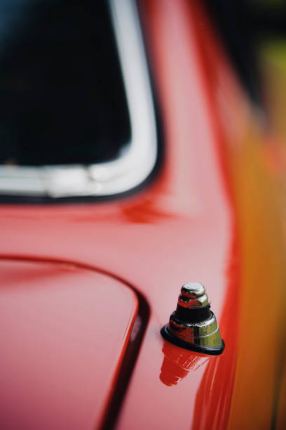 Close up shot of a radio antenna on a vintage car.